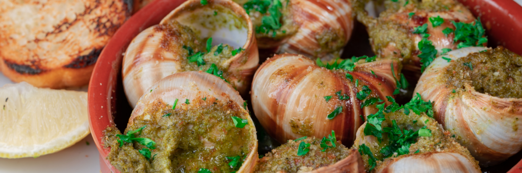 Enjoy authentic French cuisine at Brasserie du Monde - escargots in butter and herbs